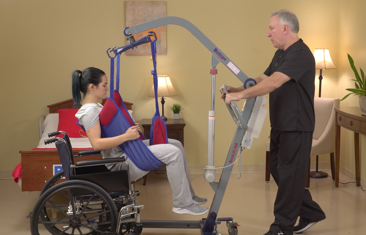 PL400 Patient Lift being used to lift patient out of a wheelchair