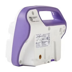 The underside of a portable medical device, likely an EKG monitor, showing a purple and white plastic housing with regulatory labels and a small gold connector port.