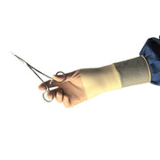 Hand wearing a yellow glove holding a pair of scissors on a white background