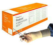 Box of Protexis surgical gloves with a hand wearing a glove holding scissors.