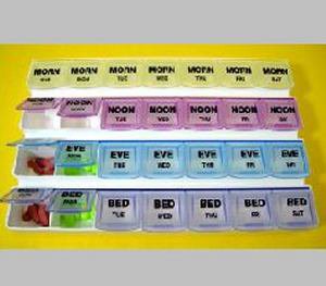 Weekly pill organizer with compartments for different times of the day on a yellow background.