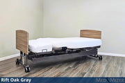 Ergonomic bed with adjustable headboard in a room setting, featuring 'Rift Oak Gray' finish.