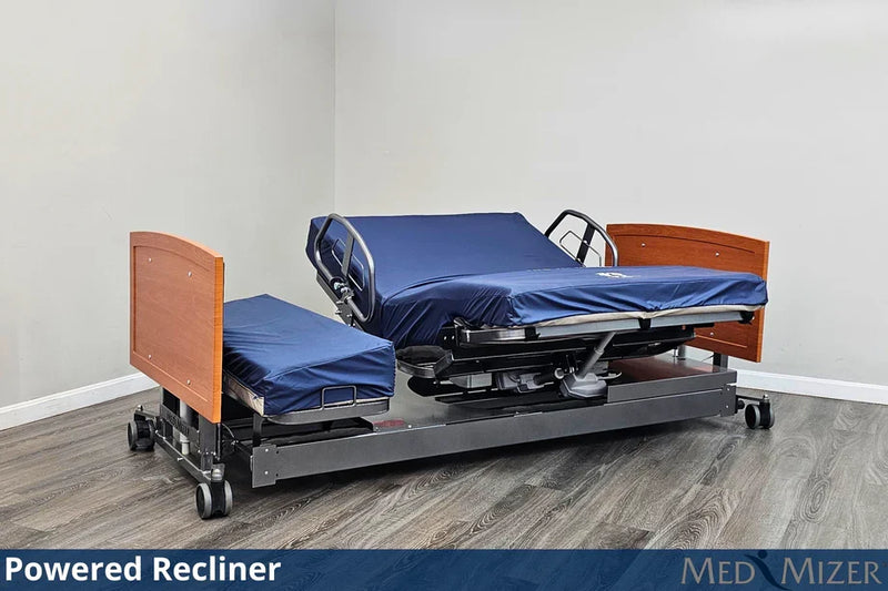 Powered recliner bed with wooden sides and blue mattress in a room setting.