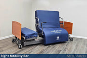 Blue Med Mizer bed with right mobility bar in a room setting
