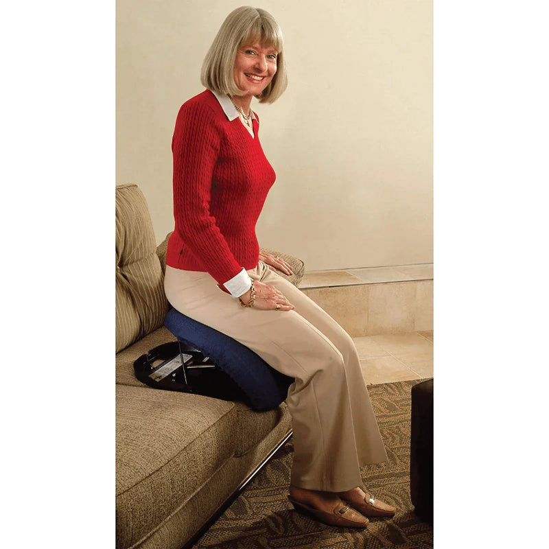 Woman sitting on a couch using a blue cushion for support