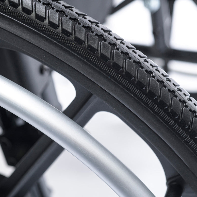 Close-up of a bicycle tire with tread pattern and metal rim.