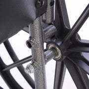 Close-up of a wheelchair metal components on a white background