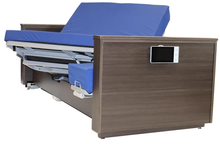 An electric adjustable hospital-style bed frame with a brown wood-grain finish, blue mattress and headboard cushion, and a built-in control panel on the side, shown on a white background.