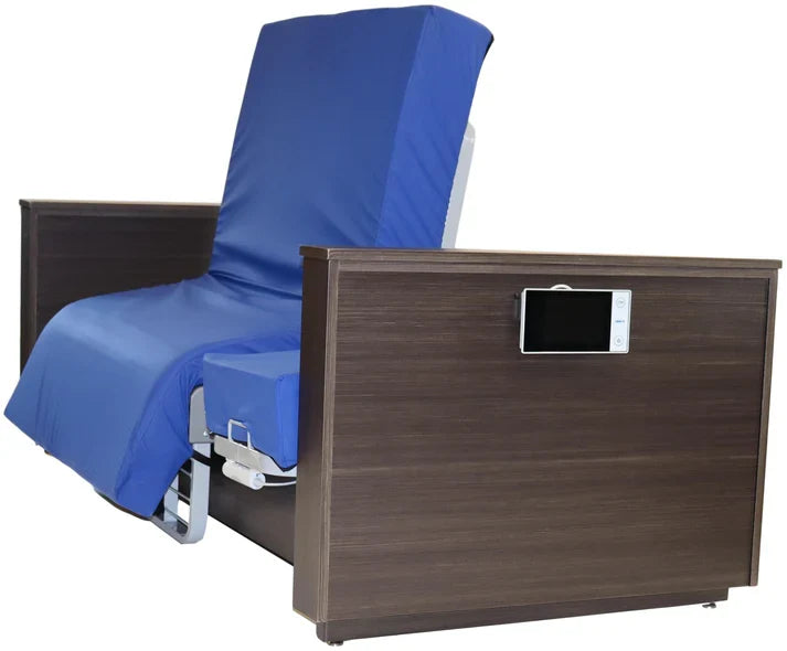 An adjustable hospital-style bed with a dark brown wood-grain frame, blue padded mattress and headrest, and a built-in control panel on the side rail, shown against a plain white background.