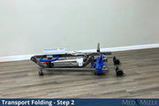 Transport folding device on a wooden floor with a plain wall background