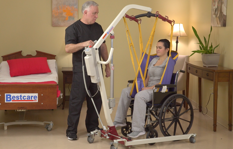 PL228 Patient Lift caregiver lifting client out of a wheelchair
