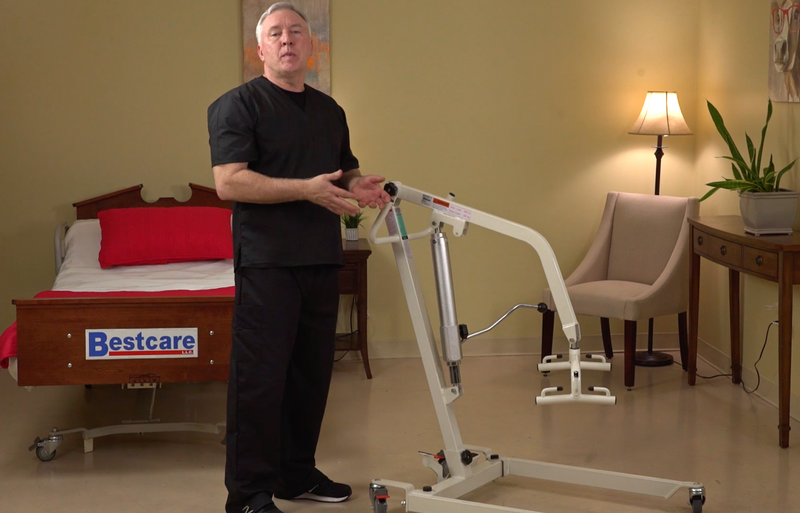 PL400HE patient lift left side view with Caregiver