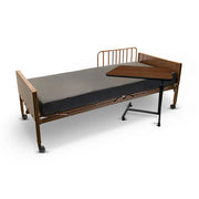 Medical bed with wooden frame and attached tray on a white background
