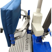 Close-up of a Medizer chair support or attachment system with a blue padded cushion, silver metal arms, blue plastic joints, and part of a white-and-blue machine base.