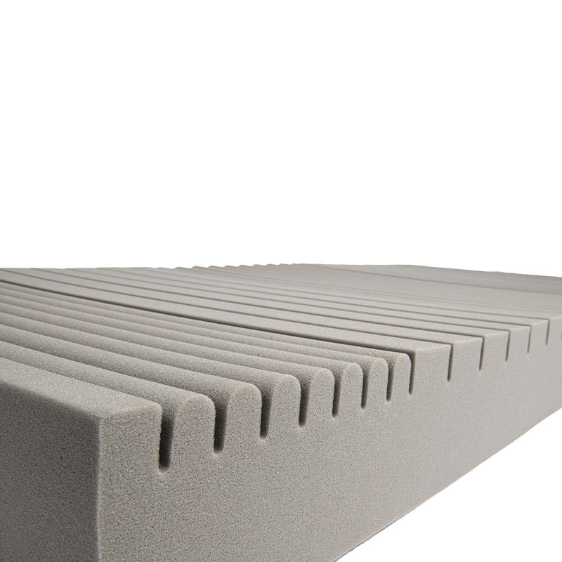 Close-up of a textured gray foam block with a white background