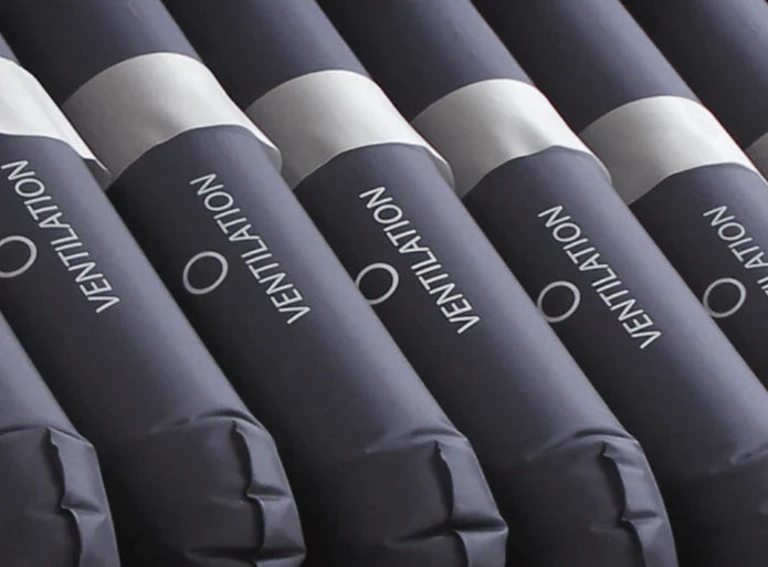 Row of blue inflatable tubes with 'Ventilation' text on a dark background