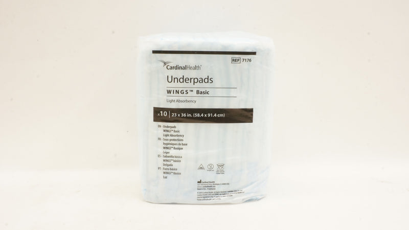 Package of Cardinal Health underpads on a beige background