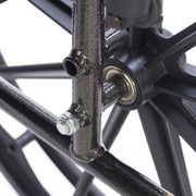 Close-up of a bicycle wheel hub with bearings and spokes on a white background
