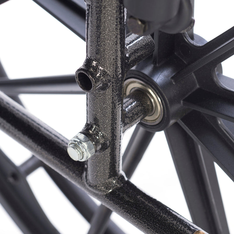 Close-up of a bicycle wheel hub with bearings and spokes on a white background