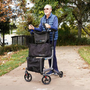 Man using a rollator with bags on a sidewalk