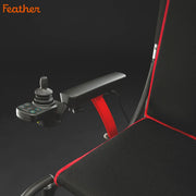 Control joystick with red armrest on a black gaming chair, featuring the brand 'Feather'.