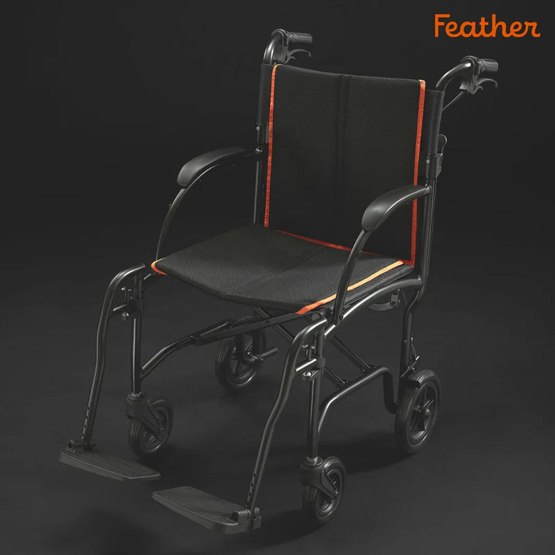 Black and orange wheelchair with 'Feather' branding on a dark background