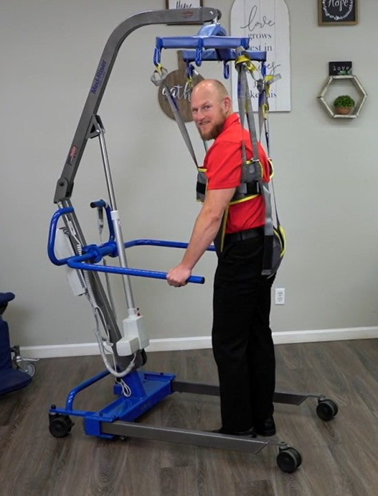 Man using a Gait Attachment on a patient lift 