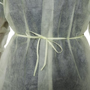 Close-up of a sheer dress with a light green ribbon on a white background
