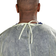 Person wearing a gray medical gown with a neck tie on a white background