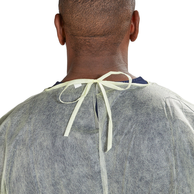 Person wearing a gray medical gown with a neck tie on a white background