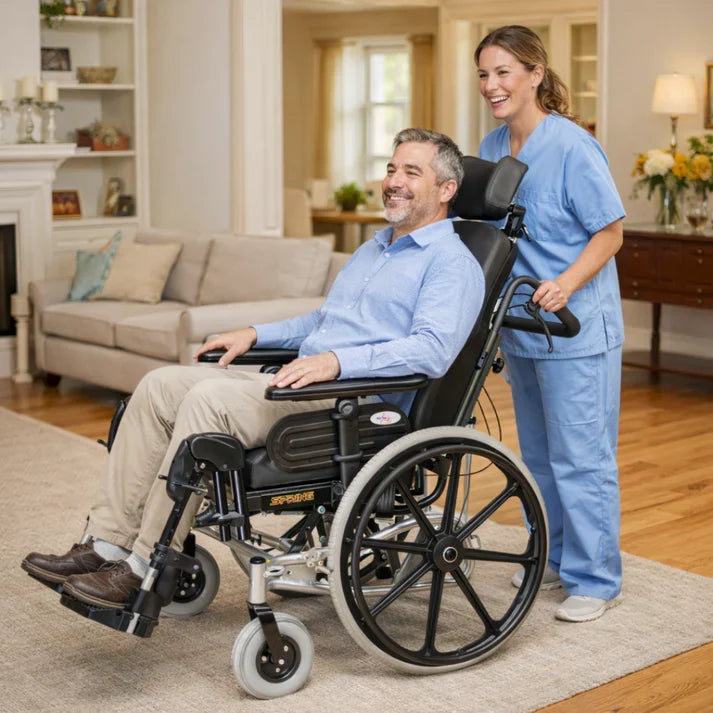 Man in a wheelchair being pushed by a caregiver in a home setting