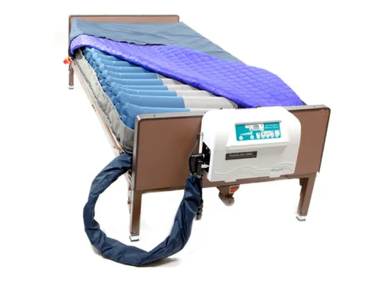 Medical bed with air mattress and blue strap on a white background