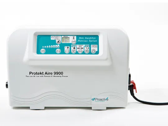 Proakt Aire 9900 Alternating Pressure mattress system in white with a teal control panel, shown on a white background with its power cord connected.