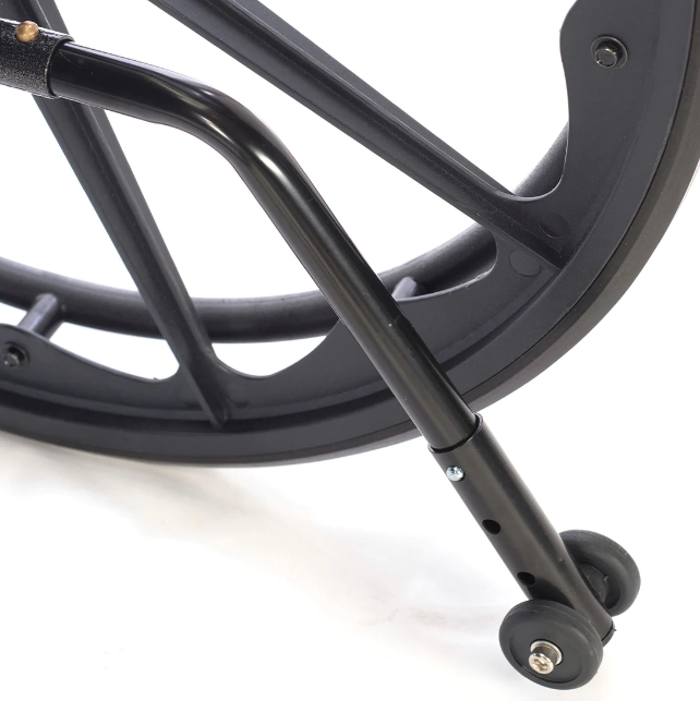 Close-up of a black metal wheel with a white background