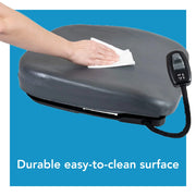 Hand cleaning a gray surface with a white cloth on a blue background