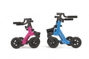 Two balance bikes, one pink and one blue, on a white background