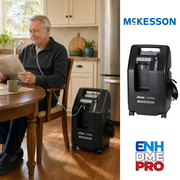 man using a concentrator at the kitchen table
