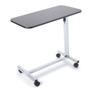 Overbed table with a dark gray top and chrome frame on a white background