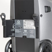 Close-up of a oxygen concentrator with a warning label on the backrest.