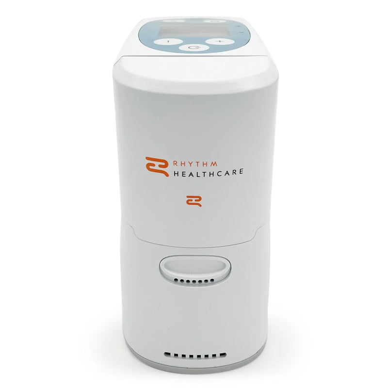 A white concentrator with a digital display and buttons on top, featuring the 'Rhythm Healthcare' logo in orange and black on the front, set against a plain white background.