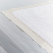 Close-up of a fabric swatch with white, beige, and gray colors.