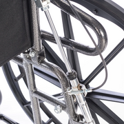 Close-up of a wheelchair frame with visible components on a white background