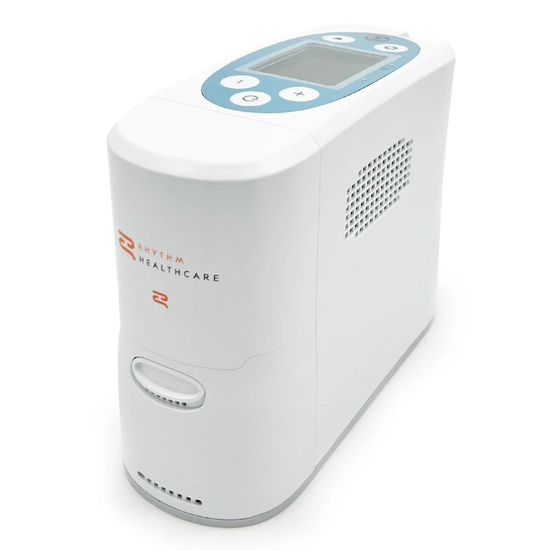 A white digital pulse concentrator by Rhythm Healthcare, featuring a light blue top control panel with a small screen and white buttons, set against a plain white background.