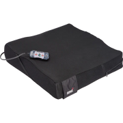 Black cushion with a remote control on a white background