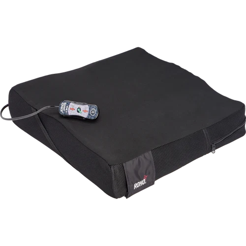 Black cushion with a remote control on a white background