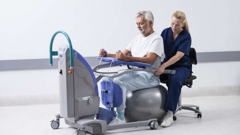 Person using a medical device with a healthcare professional assisting in a clinical setting