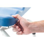 Hand holding a blue chair seat cover against a white background