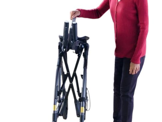 Person holding a black folding bike on a white background