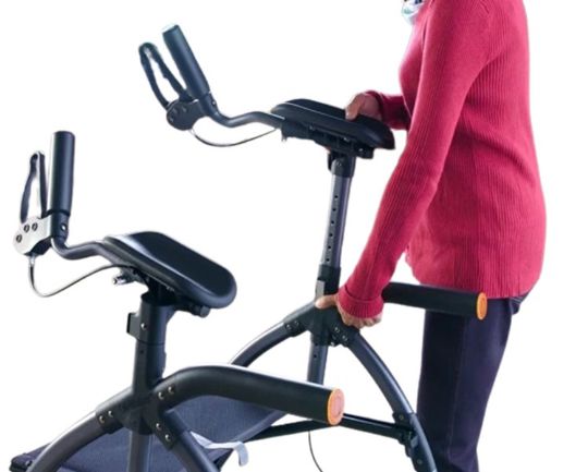 Person using a black exercise bike on a white background