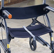 Close-up of a wheelchair with a folded seat on a concrete surface